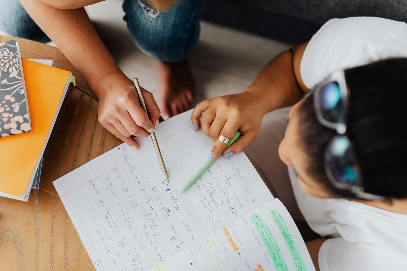Students working through math problems in a notebook